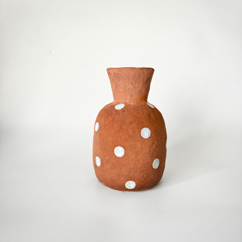 Handmade rustic terracotta ceramic vase featuring a bulbous body, flared neck, and hand-painted white polka dots, crafted by Kove Ceramics